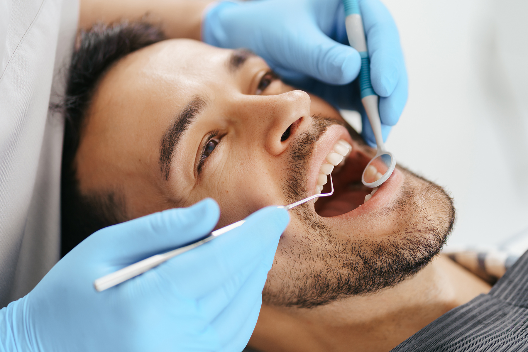 Man getting a dental cleaning in New Albany, OH